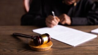 木槌と書類が置かれた机